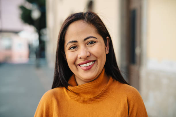 Happy filipina woman having fun smiling in front of camera in the city center