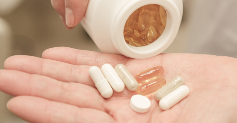 supplement capsules in a woman's hand