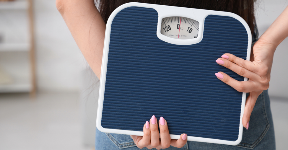 woman holding a scale