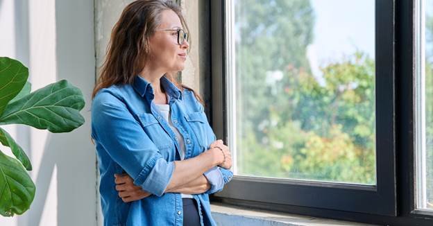 woman looking out a window